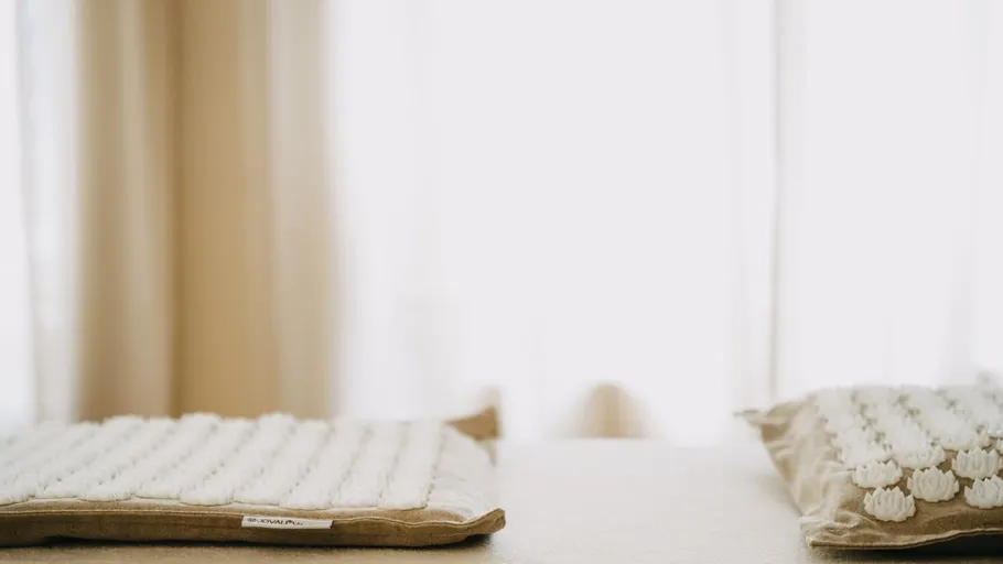 Cushions on a bed, soft natural light.