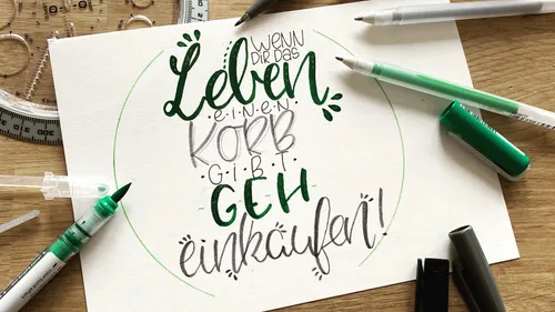 Handwritten quote on paper with drawing tools.