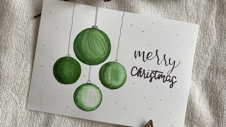 Weihnachtskarte mit grünen Kugeln, 'Merry Christmas'.