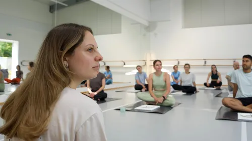 People practicing yoga in a studio.