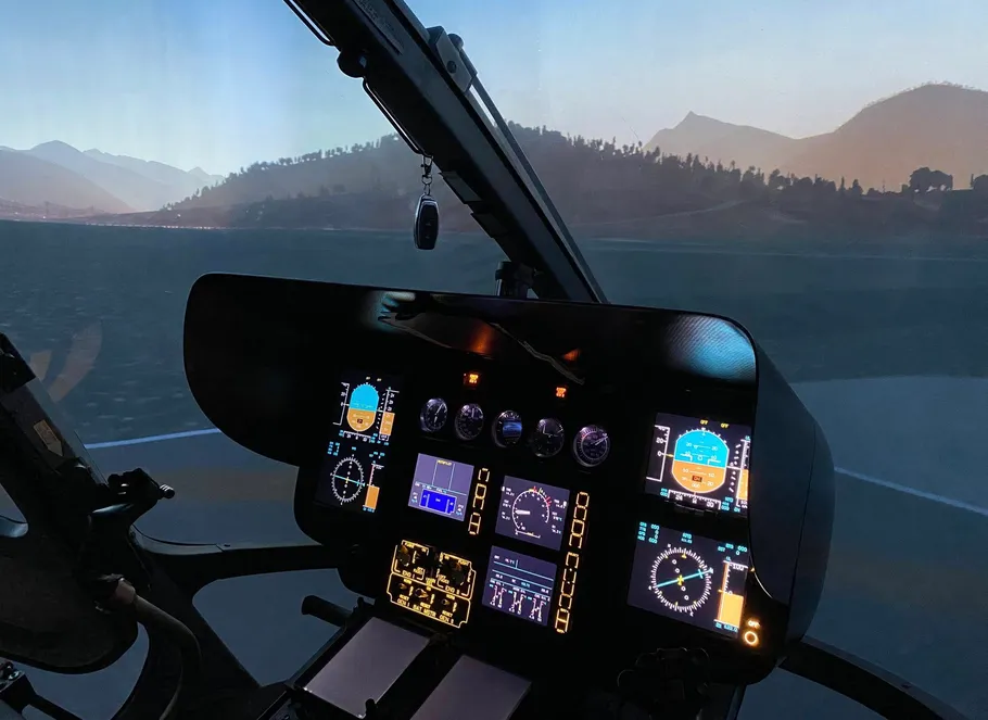 Hubschrauber-Cockpit mit beleuchteten Bedienelementen, malerische Aussicht.