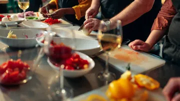 People chopping vegetables in cooking class.