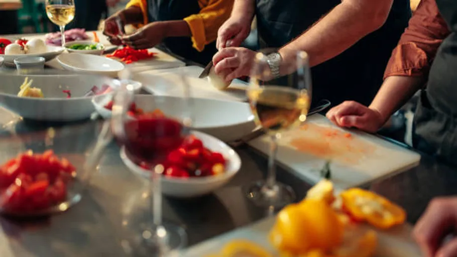 People chopping vegetables in cooking class.