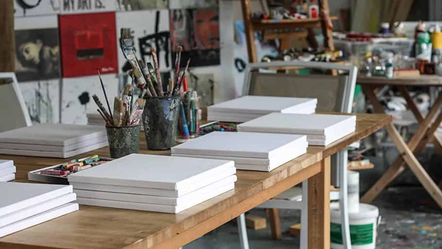 Art studio table with blank canvases.