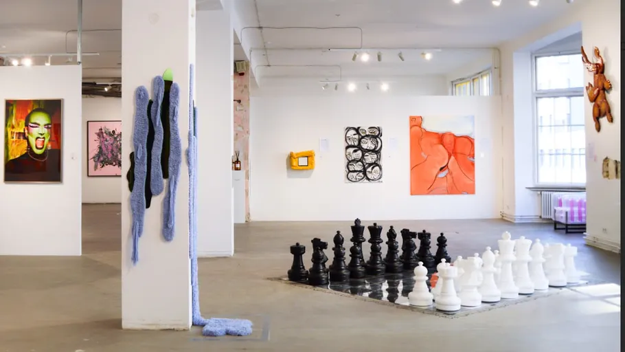 Art gallery with sculptures and paintings displayed.