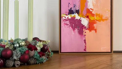 Abstract painting next to green candle wreath.