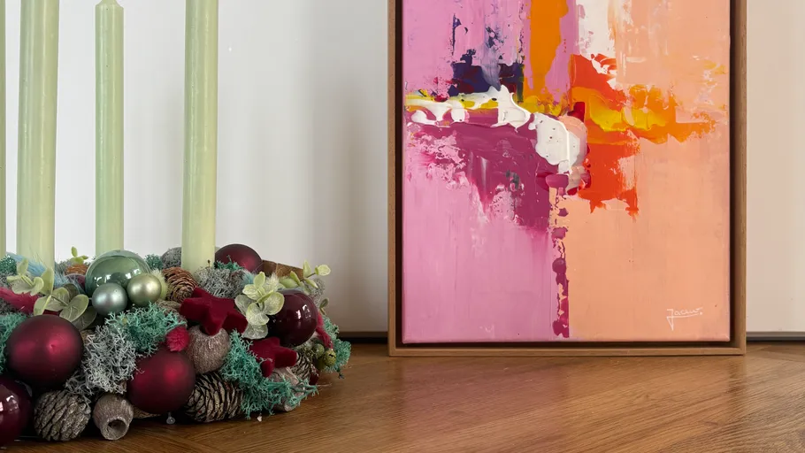 Abstract painting next to green candle wreath.