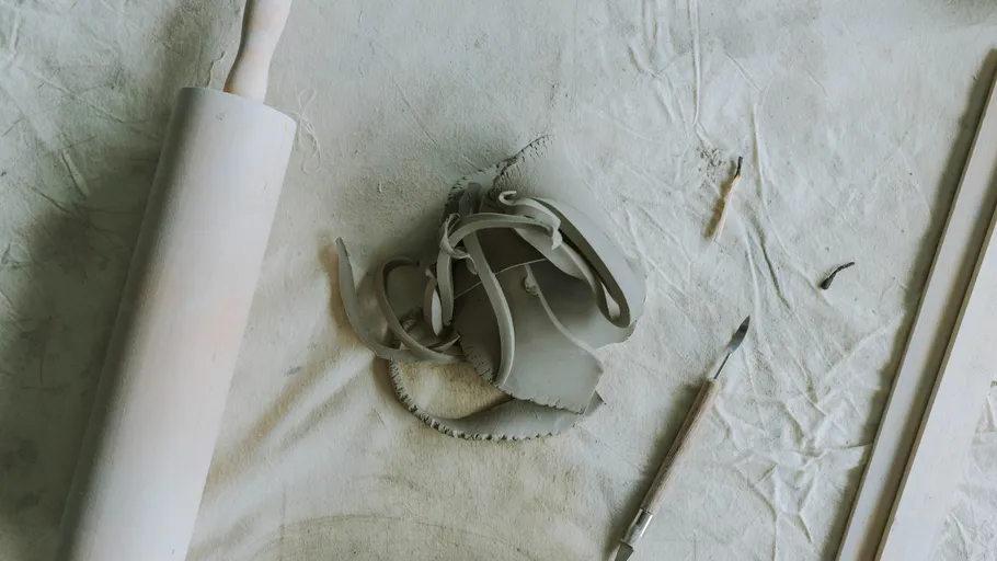 Clay and tools on a textured surface.