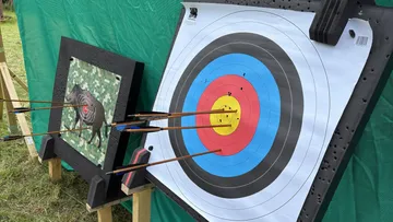 Targets with arrows in outdoor archery range.