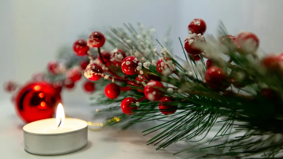 Decorative berries and candle with greenery.