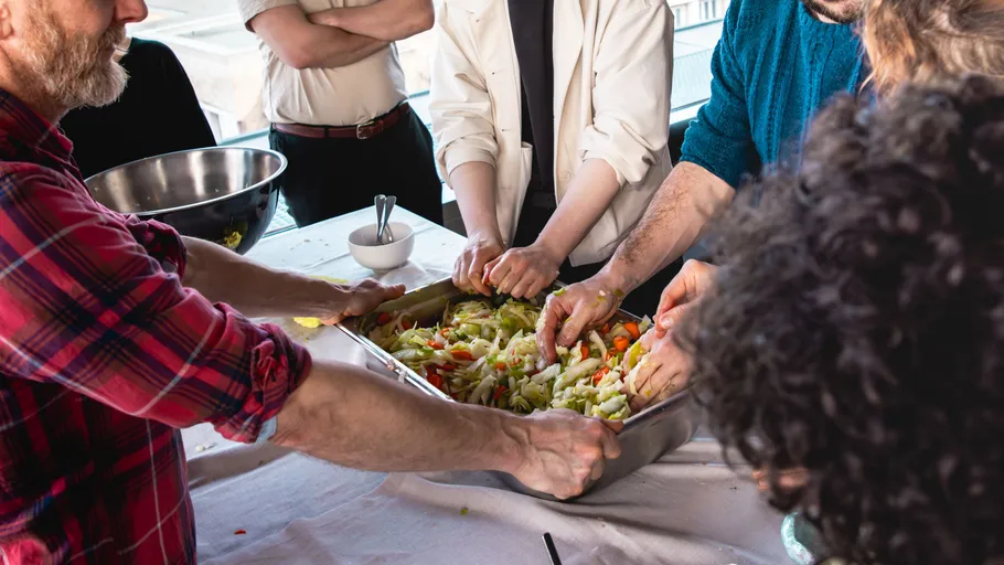 People preparing food together in kitchen.