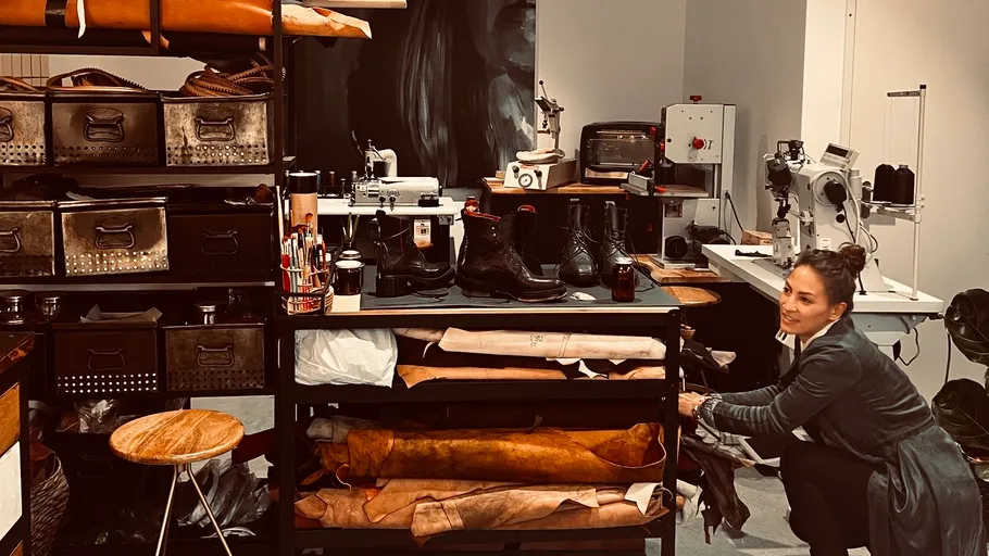 Woman arranging items in a leather workshop.