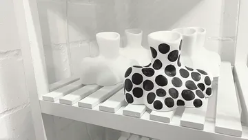 Polka dot vases displayed on a white shelf.