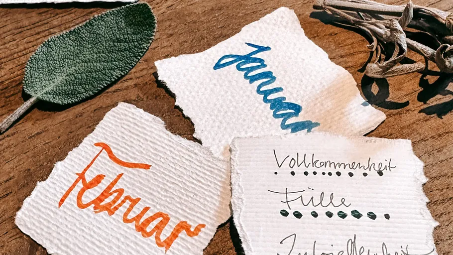 Three handwritten notes on wooden surface.