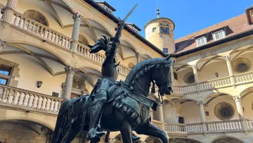 Equestrian statue in a historic courtyard.