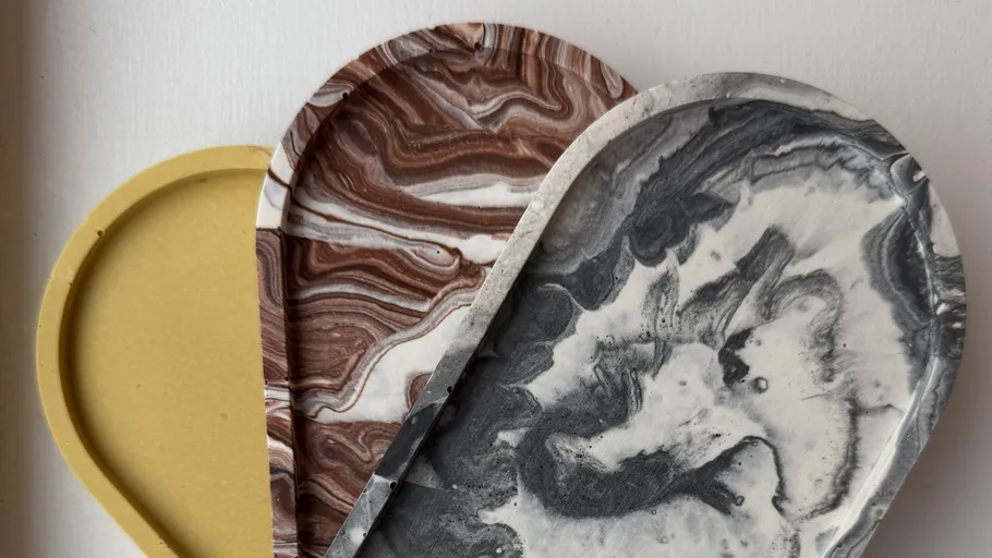 Three marbled ceramic trays overlap on surface.