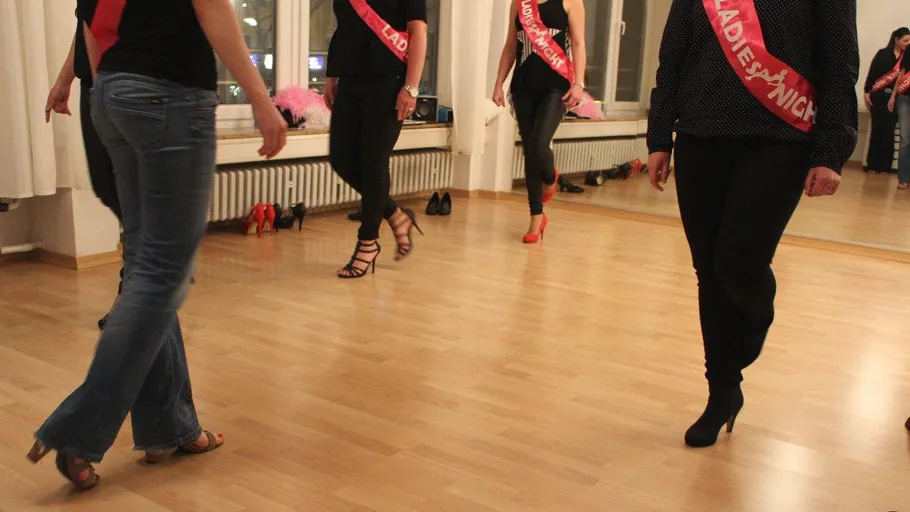 People walking in high heels indoors.