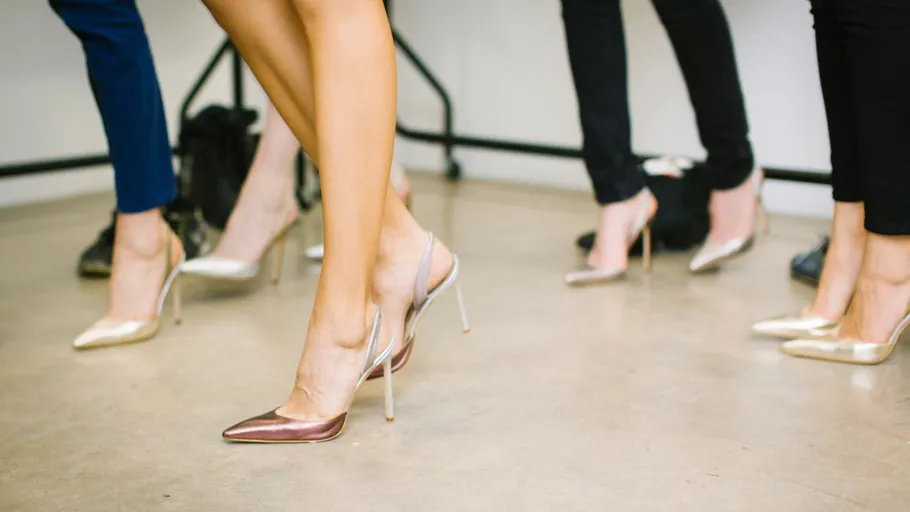 Women wearing high heels on smooth floor.