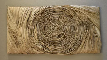 Intricate spiral artwork on wall.