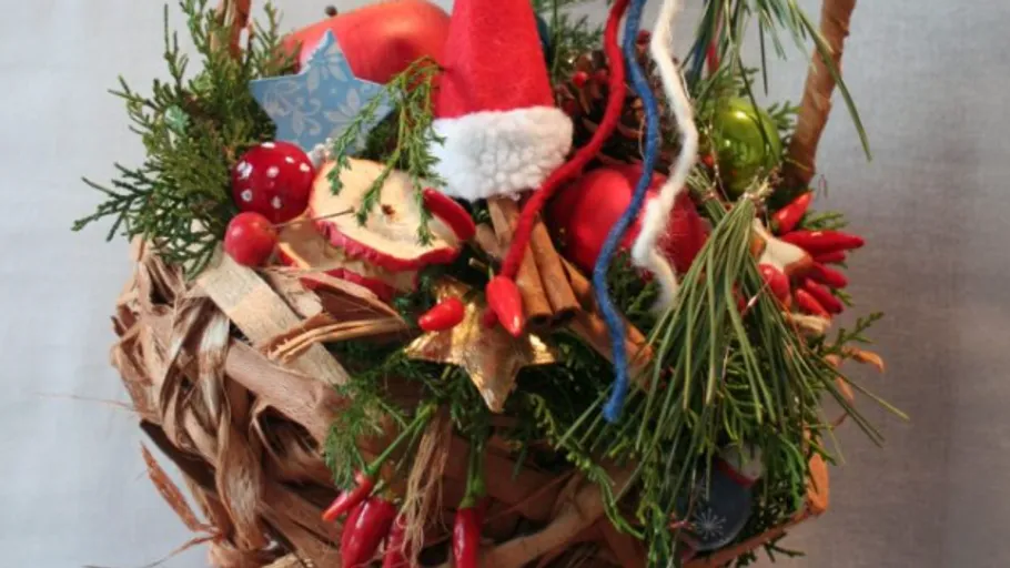 Decorative Christmas basket with festive ornaments.