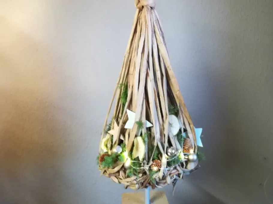 Wicker lamp with lights and decorations hanging.