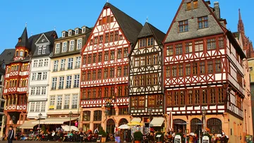 Colorful timber-framed buildings in city square.