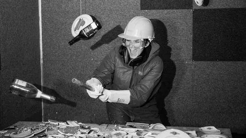 Person smashing objects in a rage room.