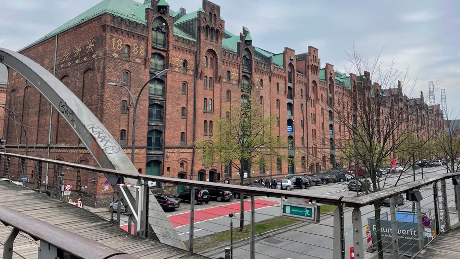 Historic red brick warehouse in urban setting.