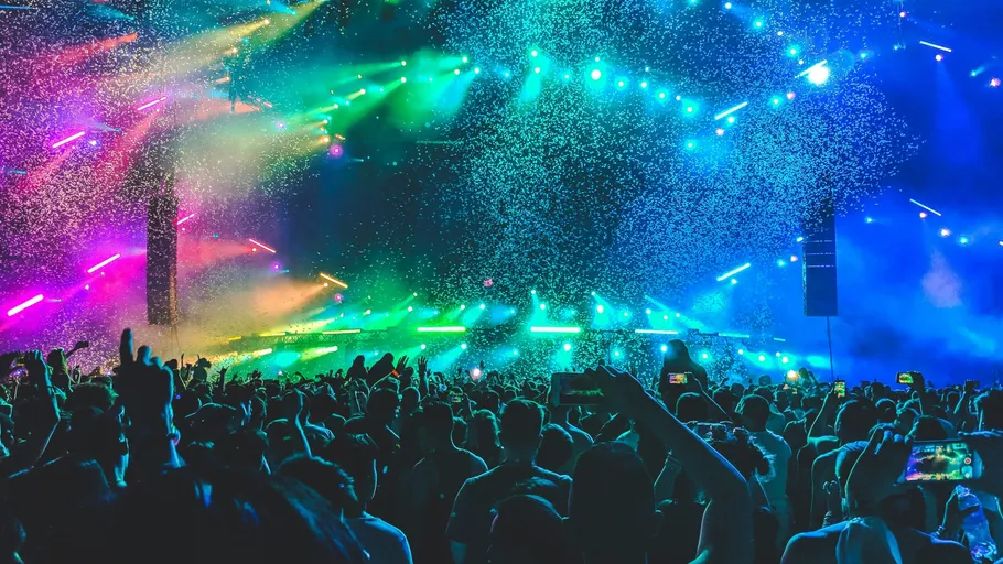 Crowd dancing at a vibrant music concert.