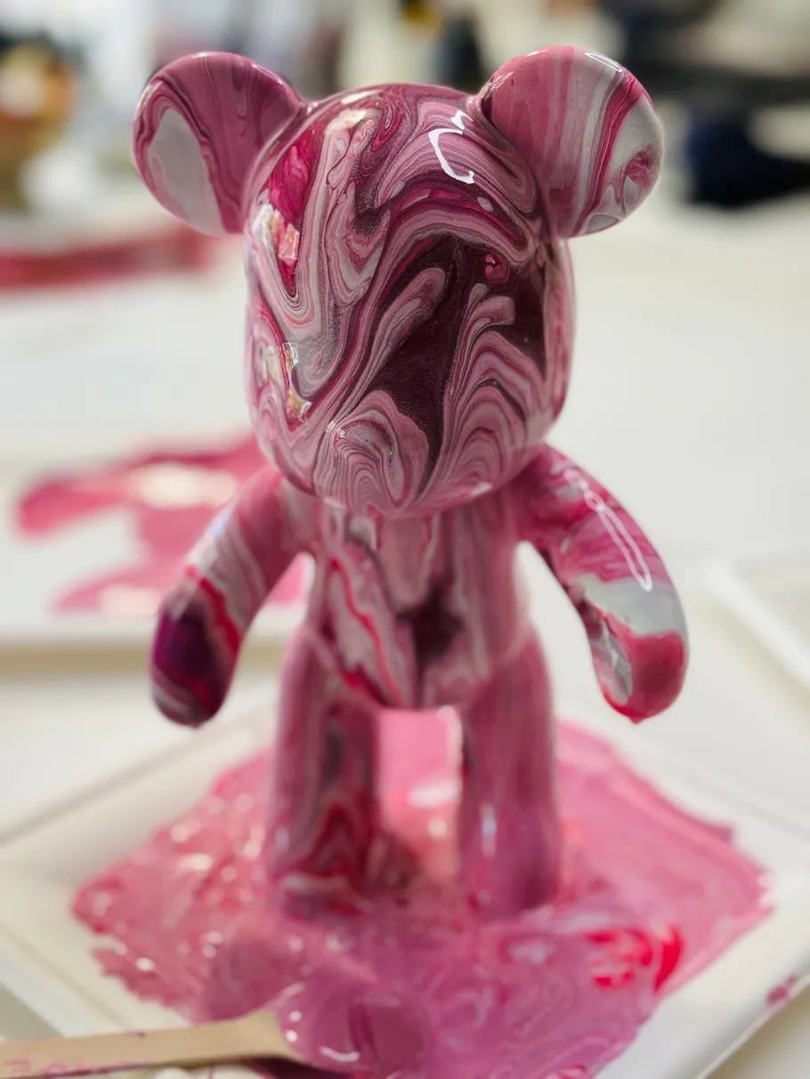 Pink marble sculpture on white background.