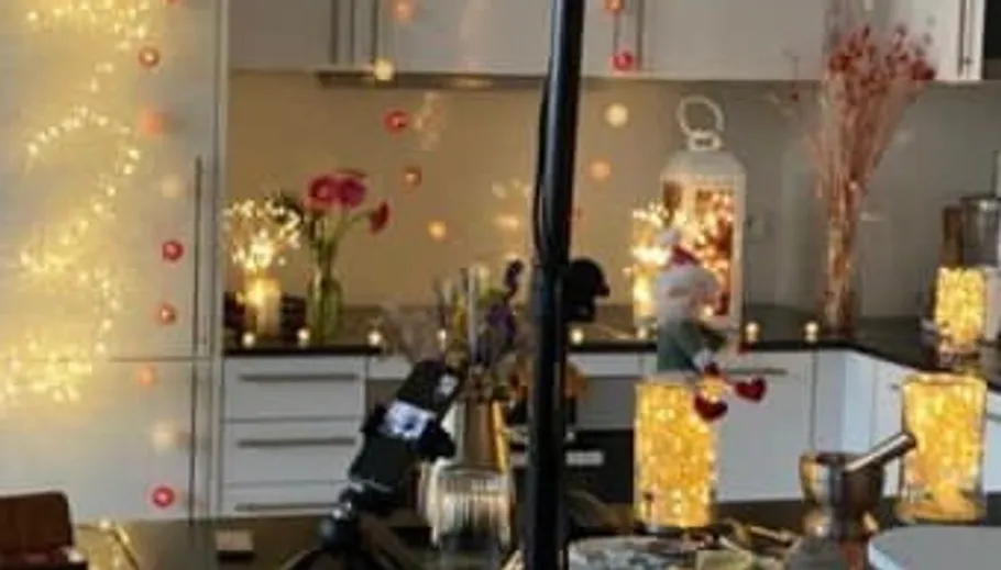 Kitchen decorated with fairy lights and flowers.