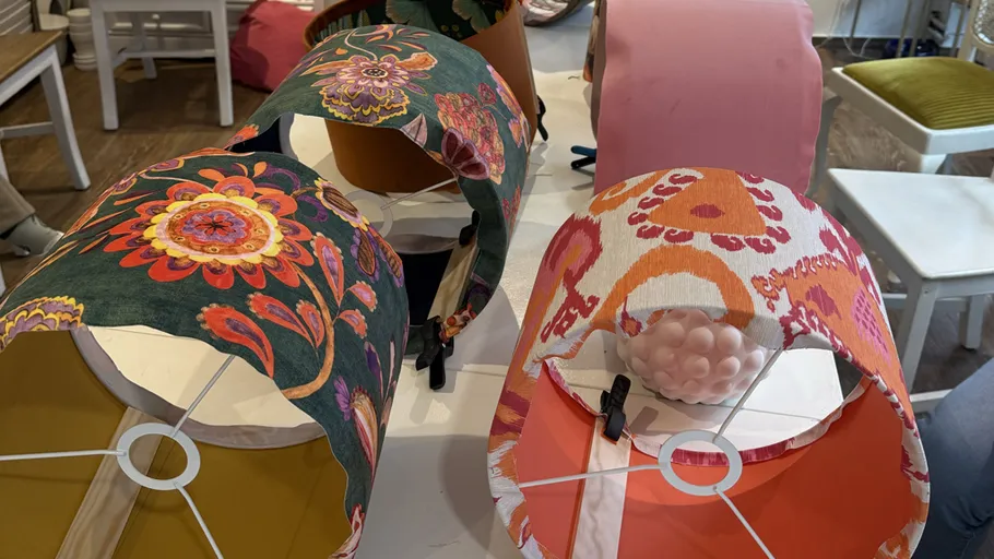 Colorful lampshades displayed on table.