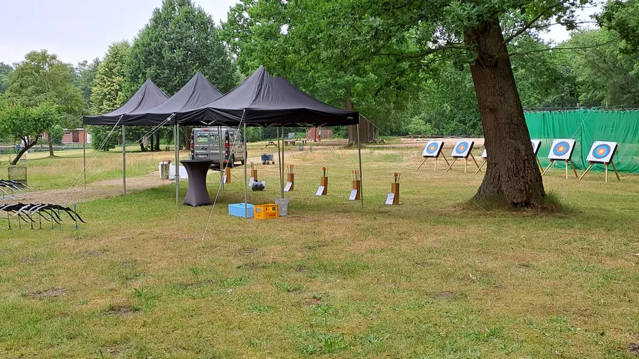 Archery range setup with targets and tents.
