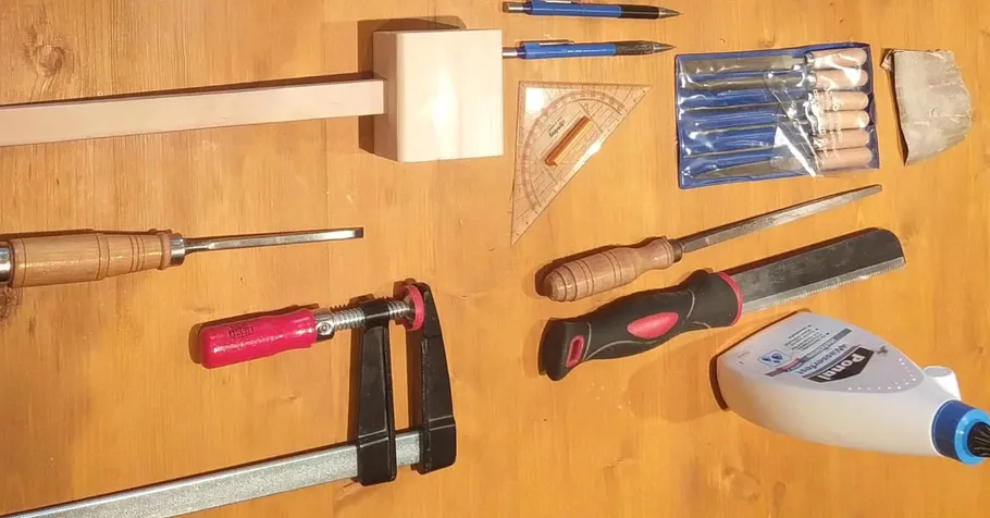 Woodworking tools arranged on a wooden surface.