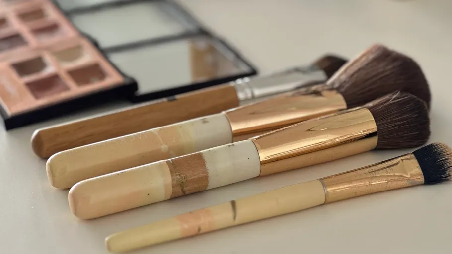 Makeup brushes lying on a table.