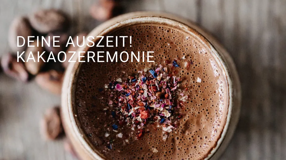 Cup of cacao with floral topping on table.