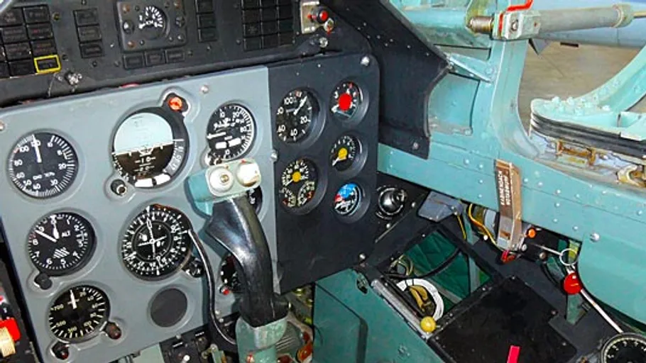 Cockpit with various aircraft instrument gauges.