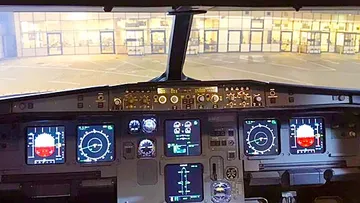 Airplane cockpit with illuminated control panels.