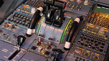 Airplane cockpit throttle levers on control panel.