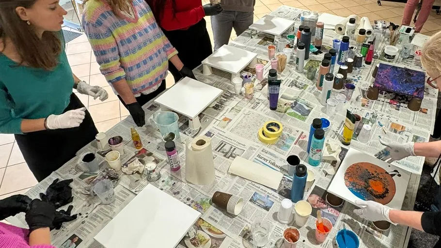 People doing acrylic pouring art activity.