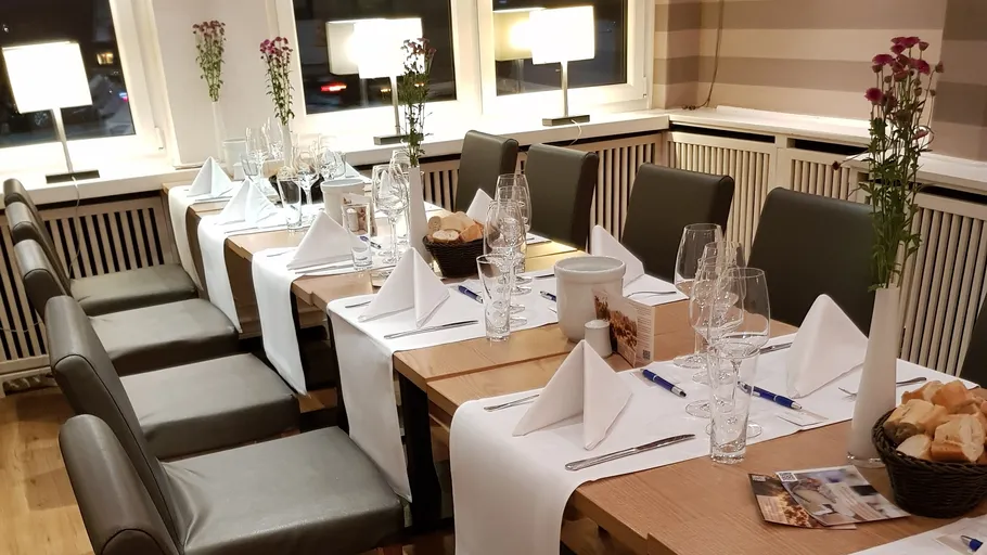 Elegantly set long table in a restaurant.