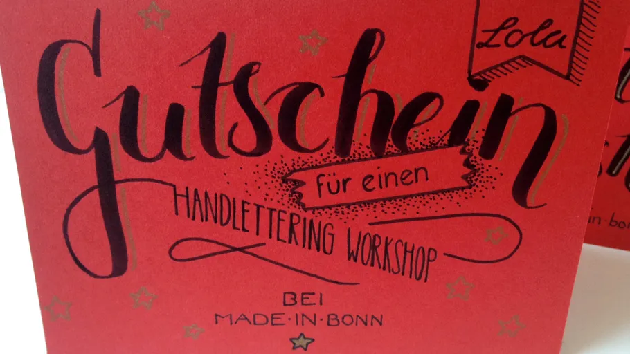 Red card with hand-lettering workshop voucher.