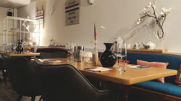 Cozy restaurant interior with table setting.