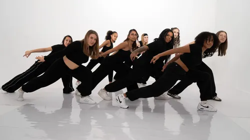 Group of dancers performing indoors.