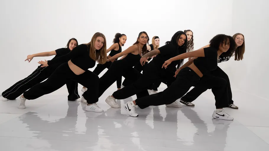 Group of dancers performing indoors.