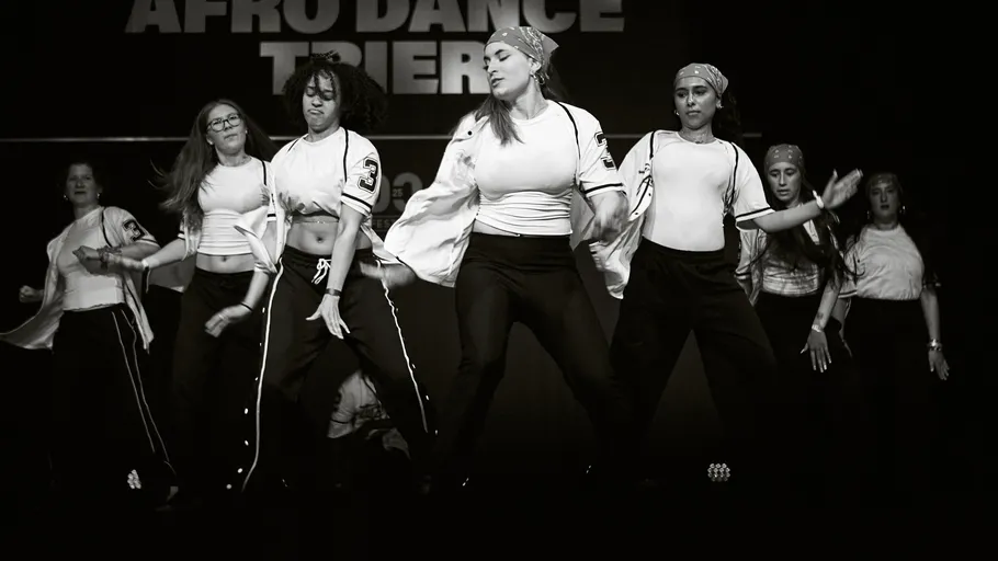 Group of dancers performing on stage.