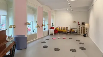 Empty room with cushions in a circle.