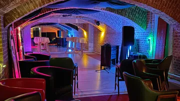Colorful chairs in a brick-walled lounge.