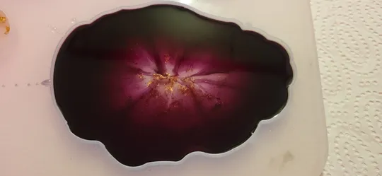 Purple resin art in irregular mold.