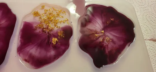 Purple resin flowers with gold flakes.
